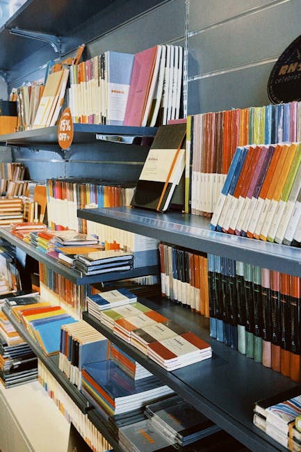 Vibrant bookshelves showcasing a diverse collection of colorful notebooks in a retail store.